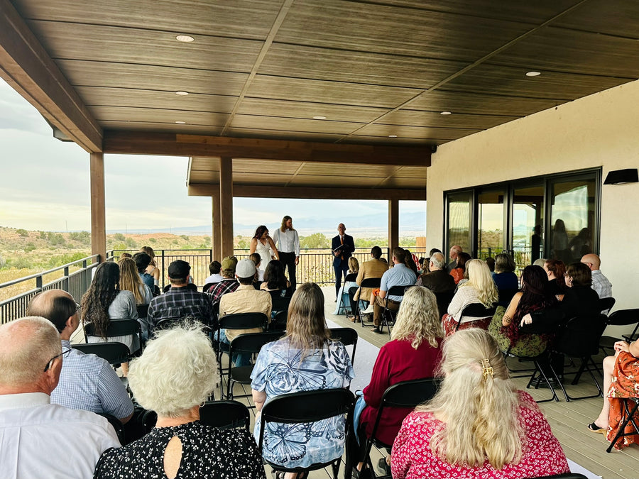 Seated guests at a deck wedding ceremony with mountain views, Observer Ranch Penrose Colorado