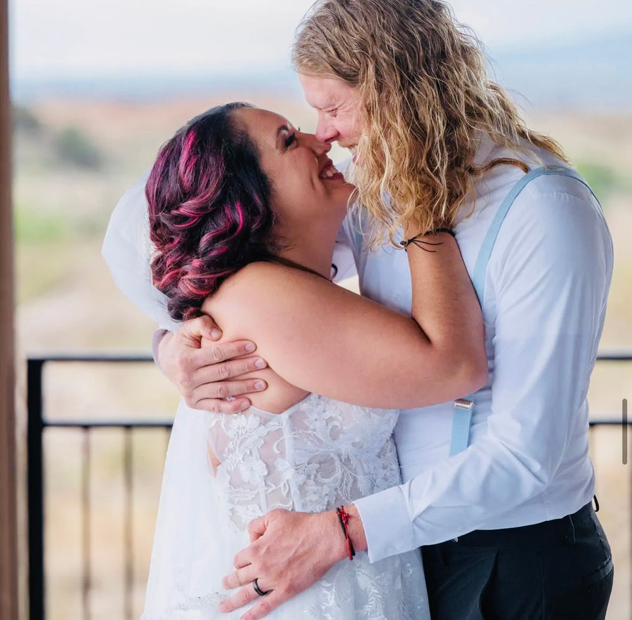 Bride and groom embrace on the deck at Observer Ranch, Penrose Colorado