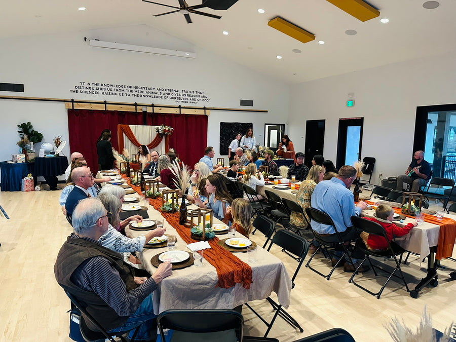 Guests seated at long tables for a wedding dinner, Observer Ranch Penrose Colorado