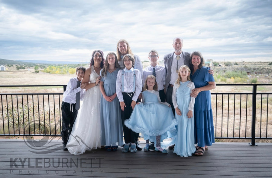Wedding party group portrait on the deck with mountain views, Observer Ranch Penrose Colorado