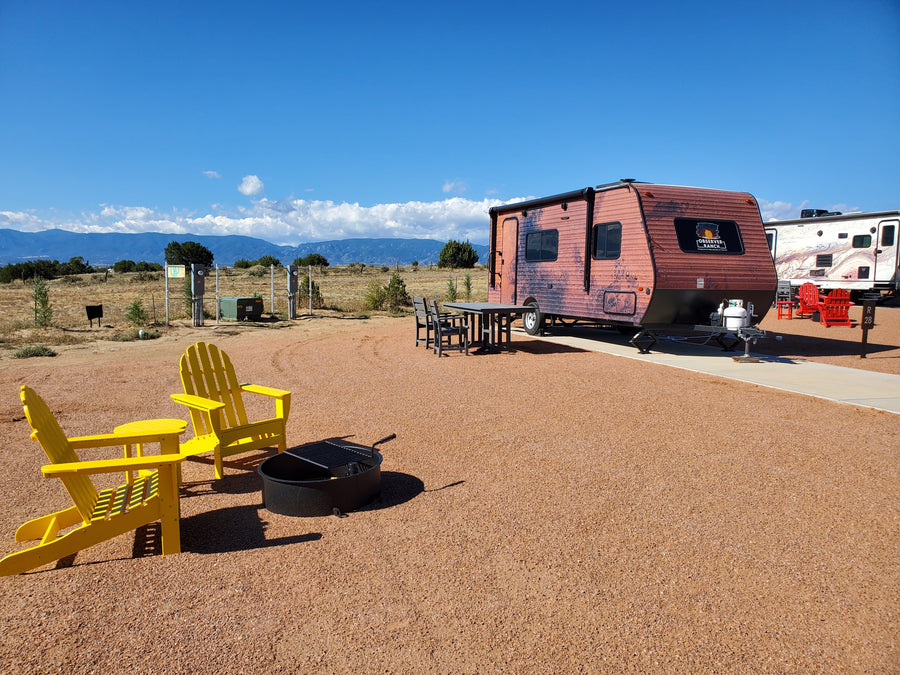 Mars planet camper with red surface vinyl wrap exterior and yellow chairs