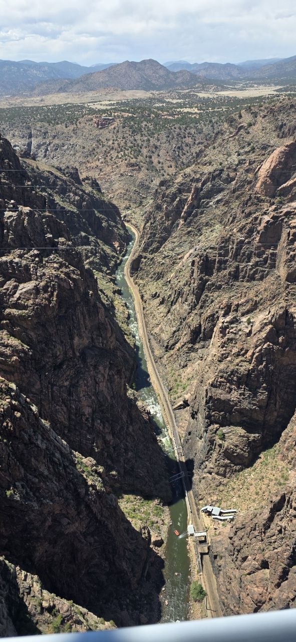 Aerial view down the Royal Gorge canyon with the Arkansas River and Royal Gorge Route Railroad near Observer Ranch, Colorado